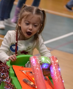 little girl plays at holiday party
