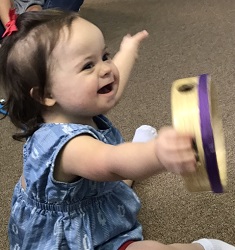 girl plays with tamborine