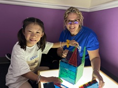 Lekotek leader and child play with lightbox